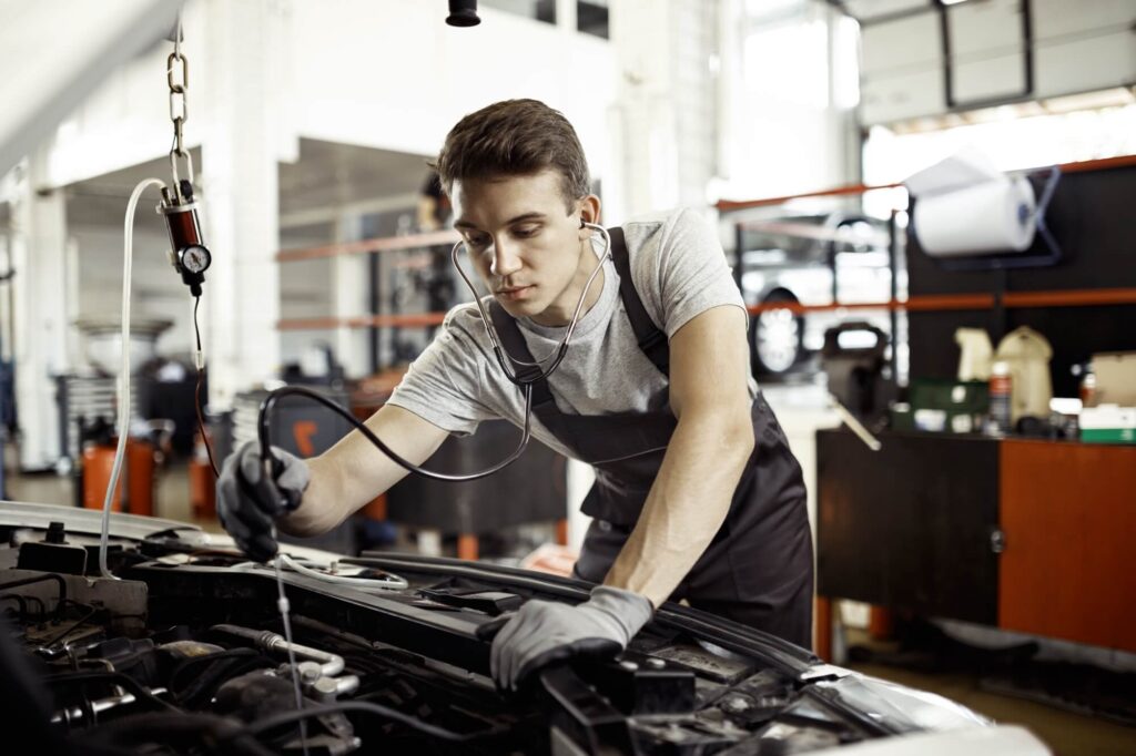 muscular-man-is-fixing-car-s-wheel-with-special-tool-at-auto-service.jpg - Bingo Tires & Auto Service in Norfolk, Virginia